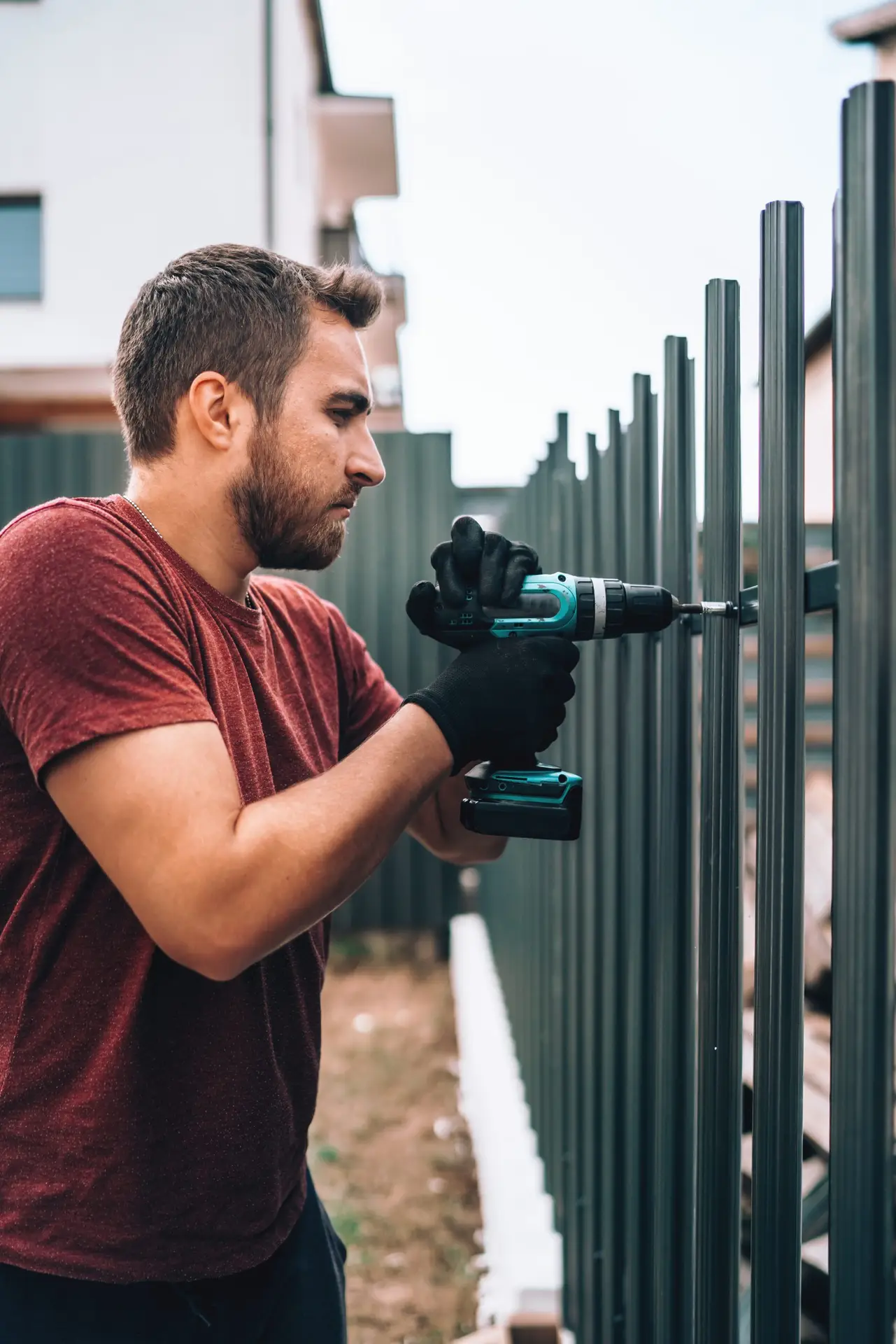 Industrial construction worker working with an electric screwdriver on the construction site